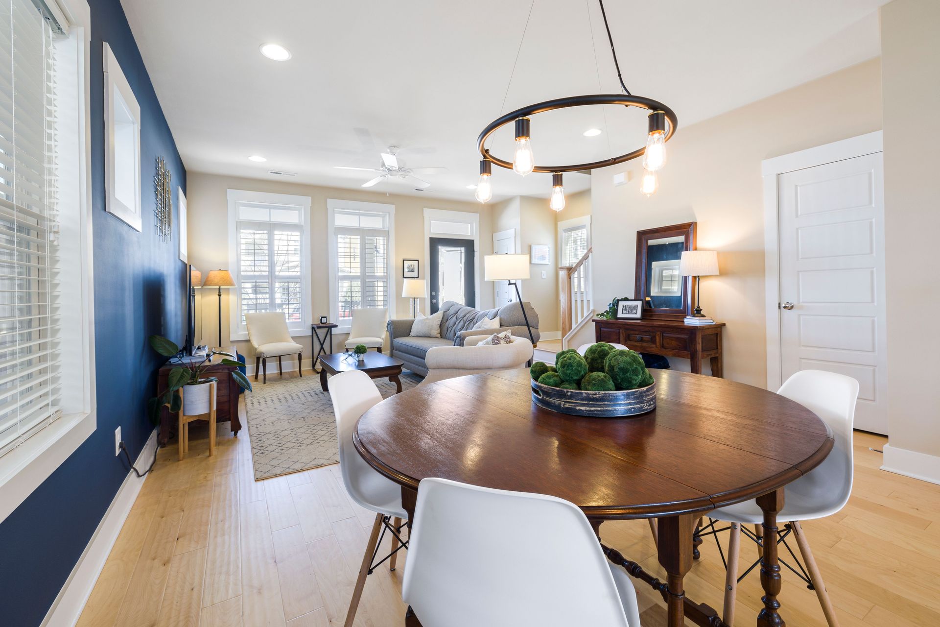 Stylish living room with dining area, featuring modern decor and elegant furnishings.
